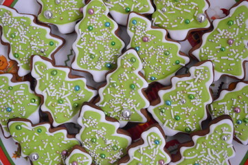 Christmas ginger cookies at green tree and many candy for background