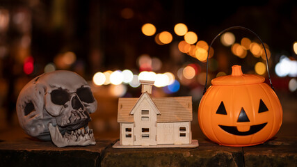 Pumpkin and skull with house designs for Halloween decoration.