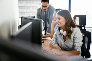 Programmers cooperating at IT company developing apps