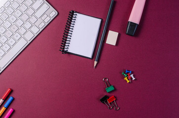Workplace background concept. Notepad, keyboard, pencil, rubber, pen, pin and paper clip. Copy space