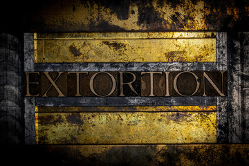 Extortion text message on textured grunge copper and vintage gold background 