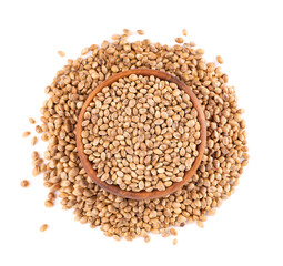 Hemp seeds isolated on white background. Dry seeds of cannabis, hemp or marijuana in wooden bowl. Top view.