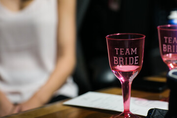 Woman or bride holding a glass of wine or champagne while she gets ready for her wedding