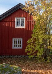 Fototapeta na wymiar Beautiful red wooden farmhouse. House painted in traditional Swedish color.