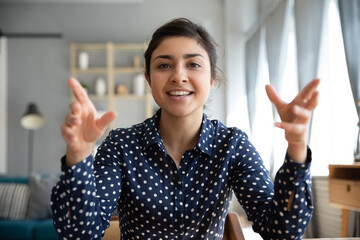 Webcam view Indian ethnicity woman sitting indoor talking using video conference call application. Tutoring on-line, easy communication remotely using modern technology and internet connection concept