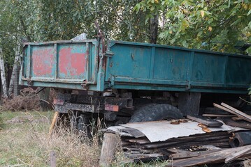 Fototapeta na wymiar green iron body of an old truck on wheels on the street
