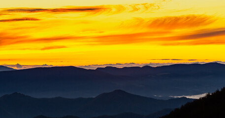 Fototapeta premium A new day begins, we see an early sunrise observed from the peaks of the Apennine Mountains.