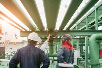 Fototapeta premium Pipe damage Engineer and supervisor Worker on Oil Tanker ship during inspection pipe damage and planning Maintenance or Repair of ship repair in shipyard.