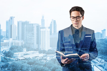 Young handsome businessman in suit and glasses thinking how to tackle the problem, new career...