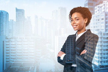 Smiling black African American business woman in suit in crossed arms pose. Bangkok cityscape. The...