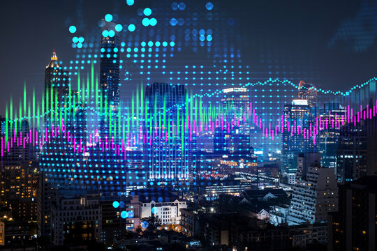 Stock market graph hologram, night panorama city view of Bangkok, popular location to gain financial education in Asia. The concept of international research. Double exposure.