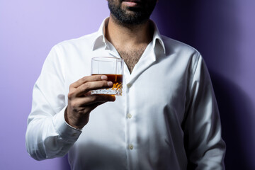 wine glass holding in hand wearing white shirt dark and moody lighting