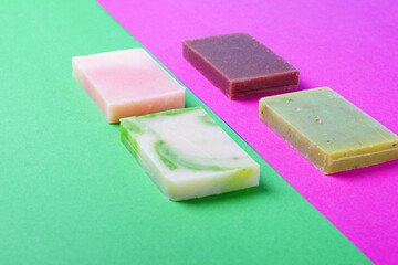 Handmade soap against the colorful geometric background. Natural body wash