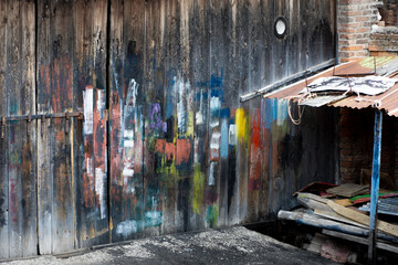 wooden wall with brush strokes in different colors at boat repair shop in Venice