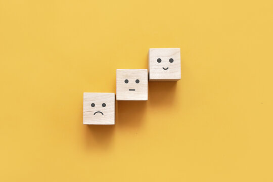 Image of different emotions on wooden cubes.