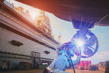 Industrial Worker at the factory welding close up under propeller maintenance and repair, ship...