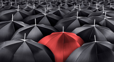 Different, unique and standing out of the crowd red umbrella. Leader or being different concept