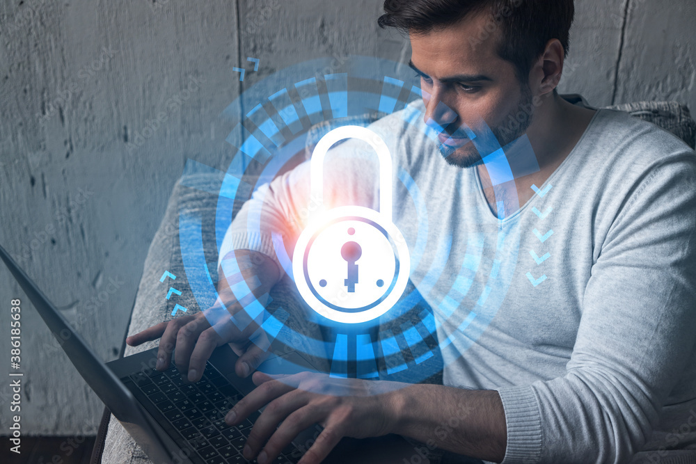 Poster a serious caucasian programmer in casual wears, using laptop to develop a new security system to pro