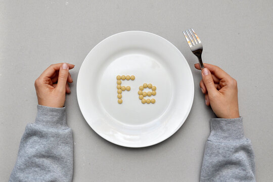 Sign of the trace element "iron" from tablets on a white plate. Iron deficiency in the body
