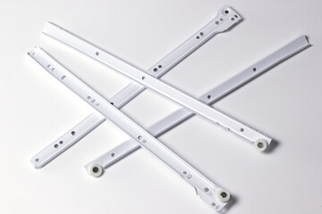 Roller guides for installation during furniture assembly, background. Drawer guides isolated on white background.