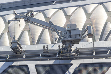 Russia, Saint Petersburg,08.09.2020. An automated construction crane lifts heavy iron beams during the construction of a skyscraper. The concept of robotics and their application in work.