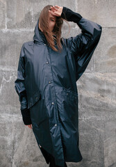 Girl on the street in a raincoat, autumn weather