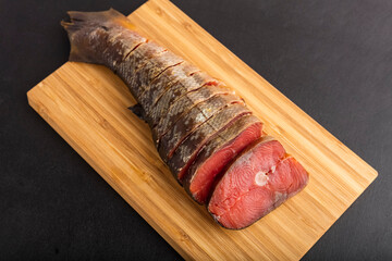 Delicious smoked fish Pink salmon, cut into pieces, on a cutting board. close-up