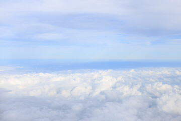 view from airplane window with white cloud and blue sky