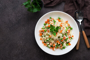 Boiled rice with vegetables, traditional Oriental dish, top view