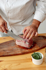 chef cutting a meat