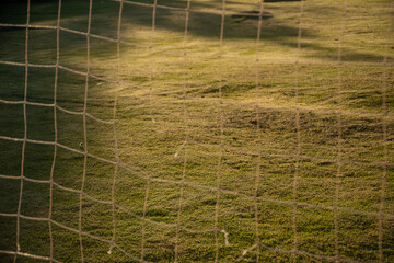 soccer field through soccer goal net