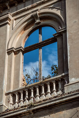 Naklejka premium Empty window without glass on facade with sky behind it