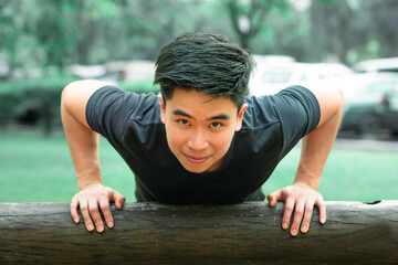 young man push up with confident in the park