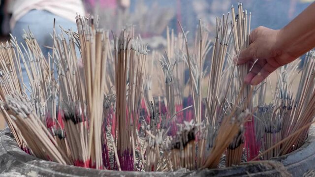 A religious ritual to worship a god or deity of Southeast Asia by lighting sixteen incense sticks and worshiping them. And embroider into a large prepared pot in Buddhist temple, Thailand.