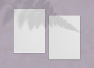 Blank vertical paper sheet with leaves shadow overlay.