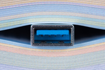 Usb cable sticks out from the book, e-learning concept