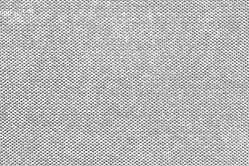 Grunge fabric texture. Monochrome light background of a harsh canvas with spots, noise and grain. Overlay template. Vector illustration
