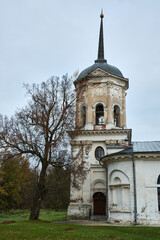 Fototapeta na wymiar An old Russian little forgotten church against the background of a gloomy autumn sky. Landscape.