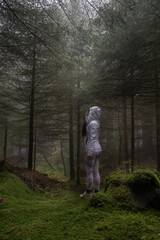 woman in the middle of the dark forest
