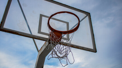Naklejka premium Basketball hoop on the background of sky, blue sky and a basketball hoop, sports with basketball hoop