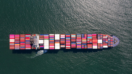 Container , container ship in export and import business and logistics. Shipping cargo to harbor by...