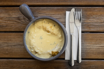 Polenta Pot, a typical italian corn porridge served with melted cheese, in Cortina D'ampezzo, famous ski resort in the Dolomites