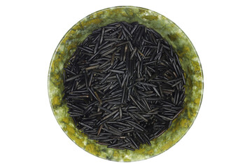 wild rice in a vintage spinach jade bowl isolated on white background