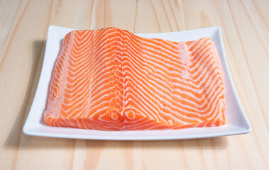 Salmon sashimi in Japanese style, Slices of raw salmon fillet on wooden blackground.