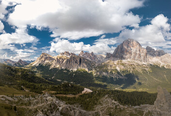 Fototapeta na wymiar Tofana di rozes and the Tofane mountains group under a blue sky with clouds in Cortina D'ampezzo, famous ski resort in the Dolomites