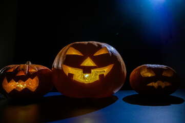 Image of several halloween jack o lanterns glowing in the dark