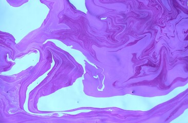 Abstract white and lilac background. Acrylic paint flows freely and creates an interesting pattern....