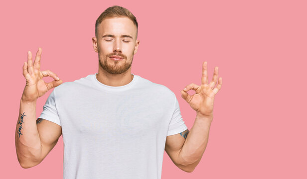 Young irish man wearing casual clothes relax and smiling with eyes closed doing meditation gesture with fingers. yoga concept.