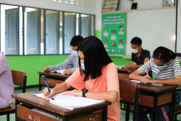 New normal  Asia school, student always wearing face mask studying in class room