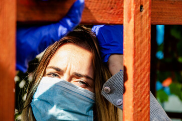 A young girl wearing a mask during the coronavirus pandemic. A mask on a woman's face during...
